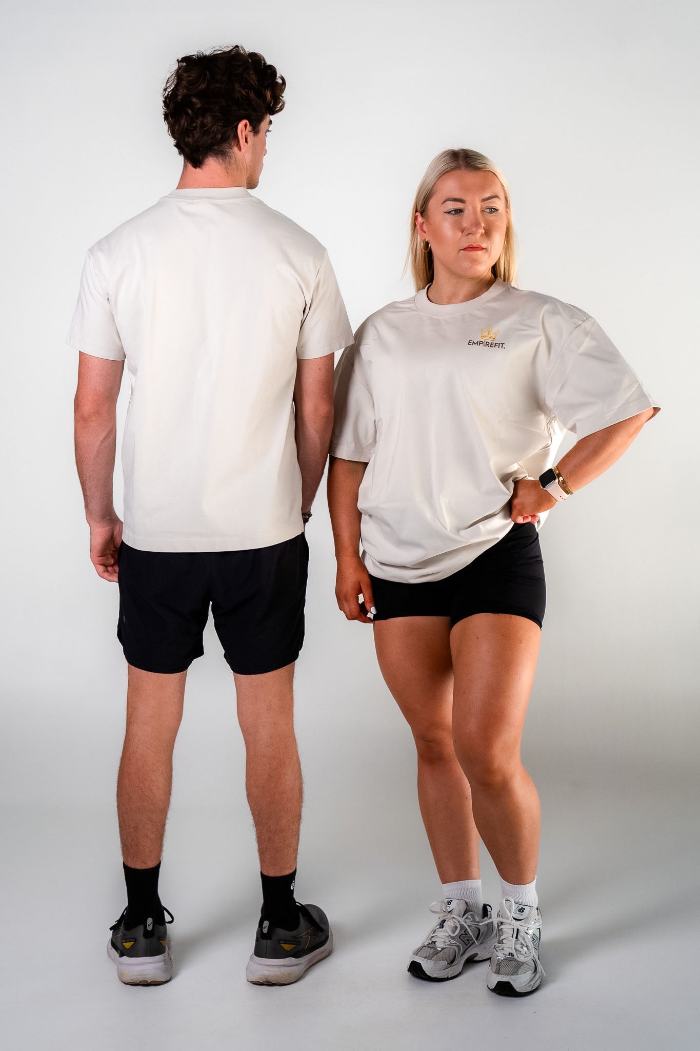 Athletes wearing the beige Essentials Crown Tee relaxed fit gym t-shirt by Empire Fit showing front and back