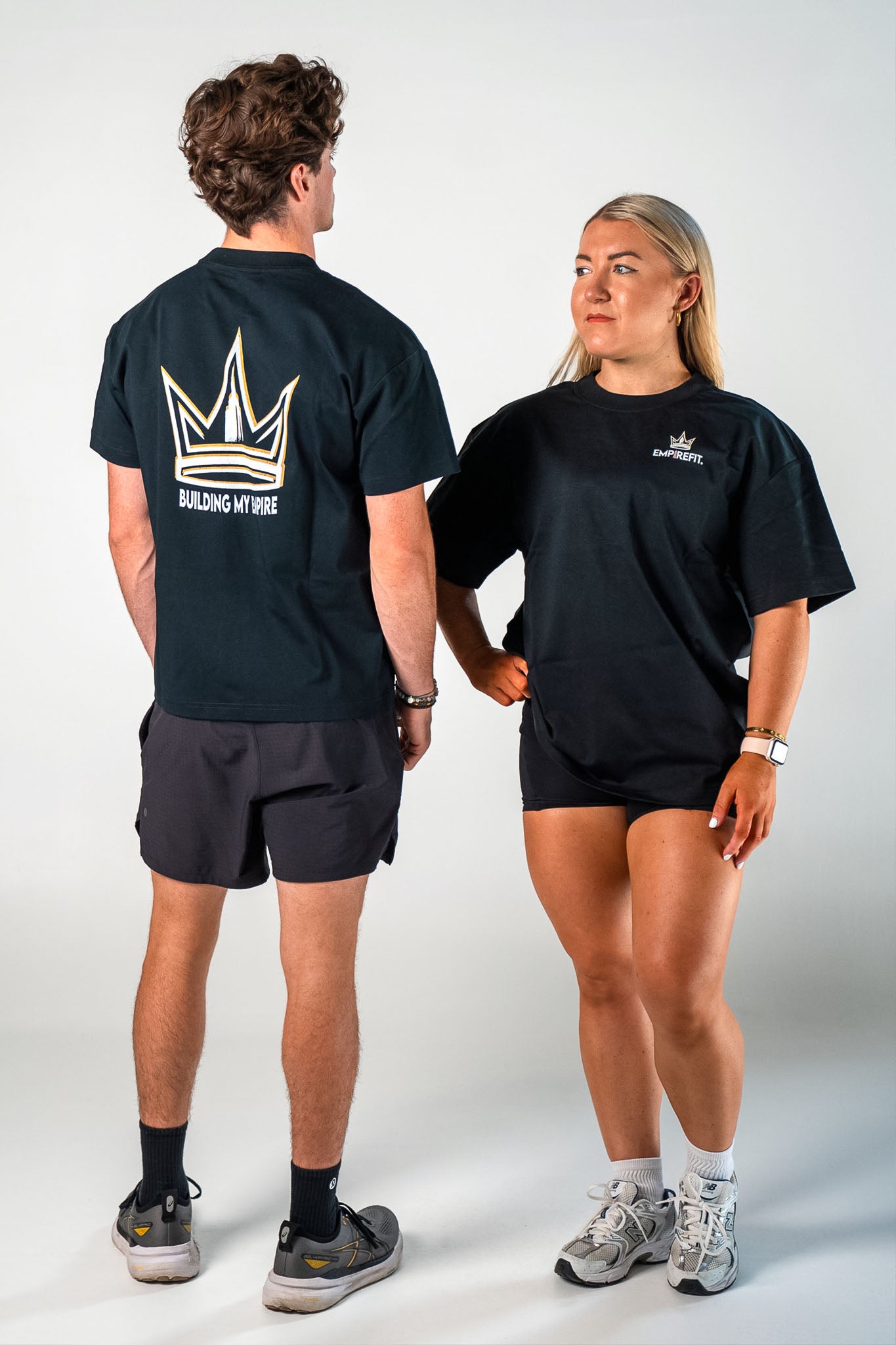 Athletes wearing the black Builders Tee relaxed fit gym t-shirt by Empire Fit front and back view