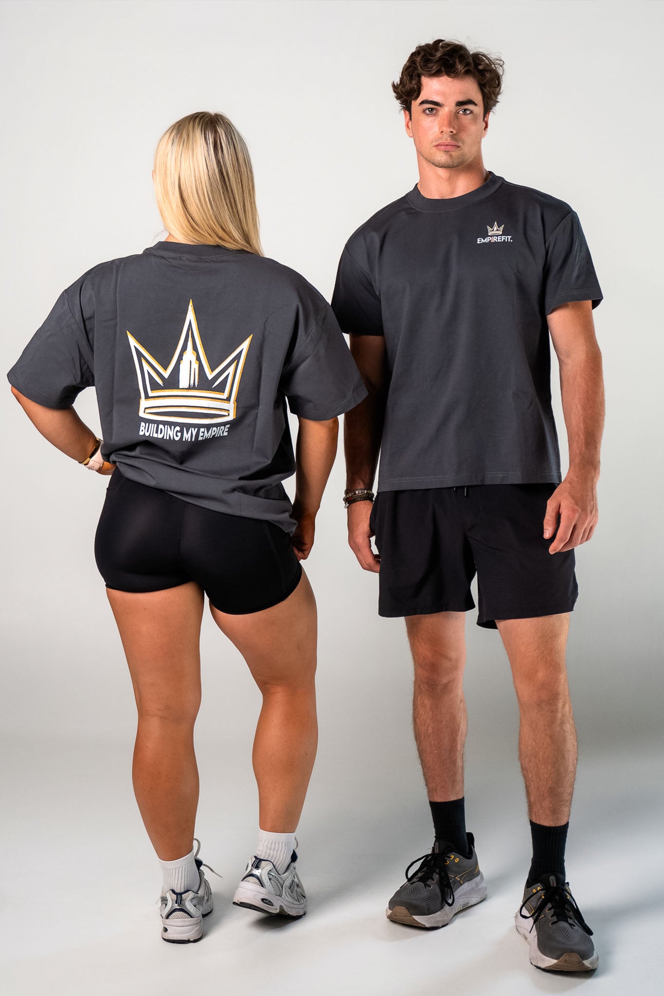 Athletes wearing the charcoal Builders Tee relaxed fit gym t-shirt by Empire Fit front and back view