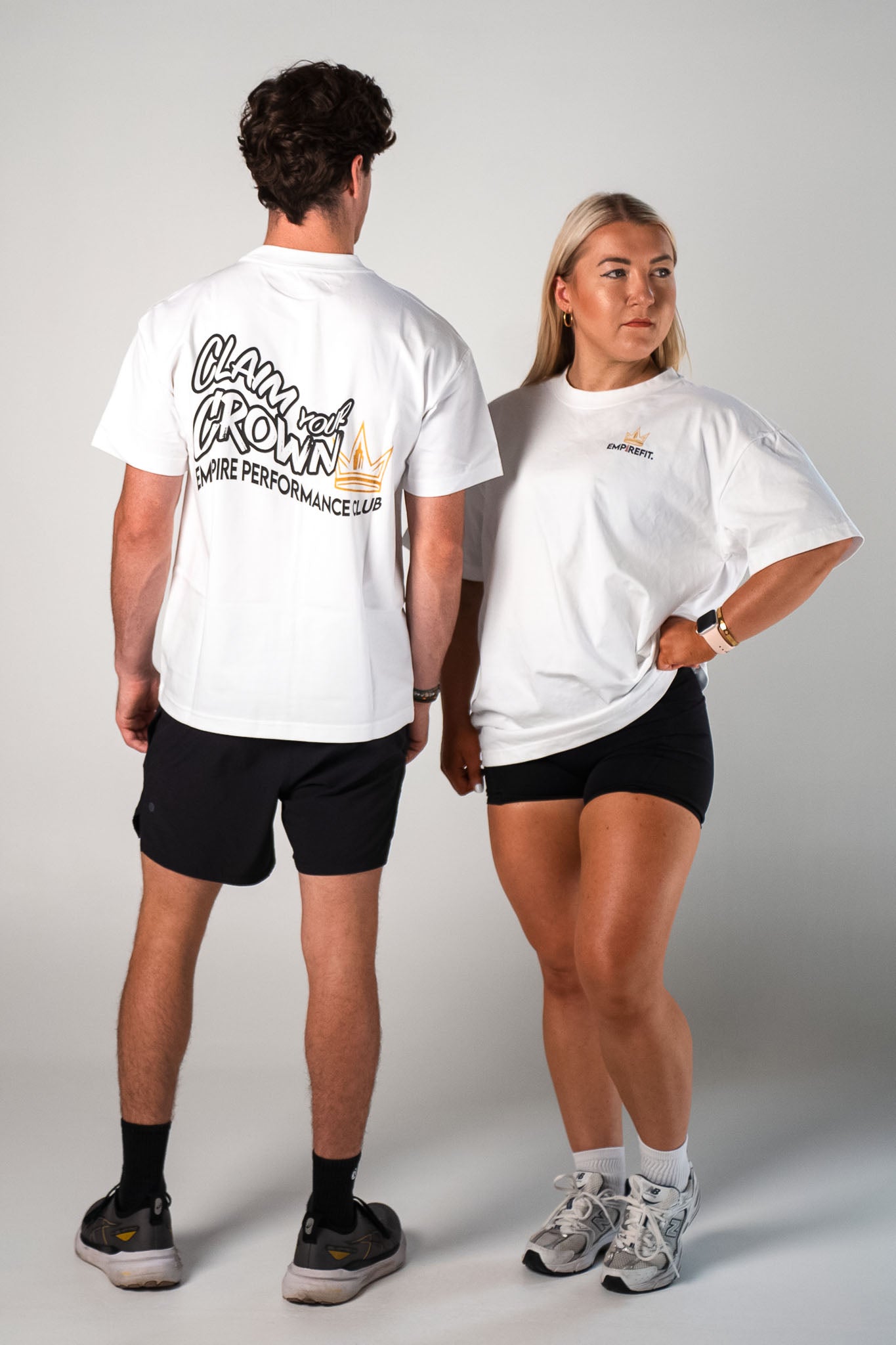 Athletes wearing the white and black Claim Your Crown Tee relaxed fit gym t-shirt by Empire Fit