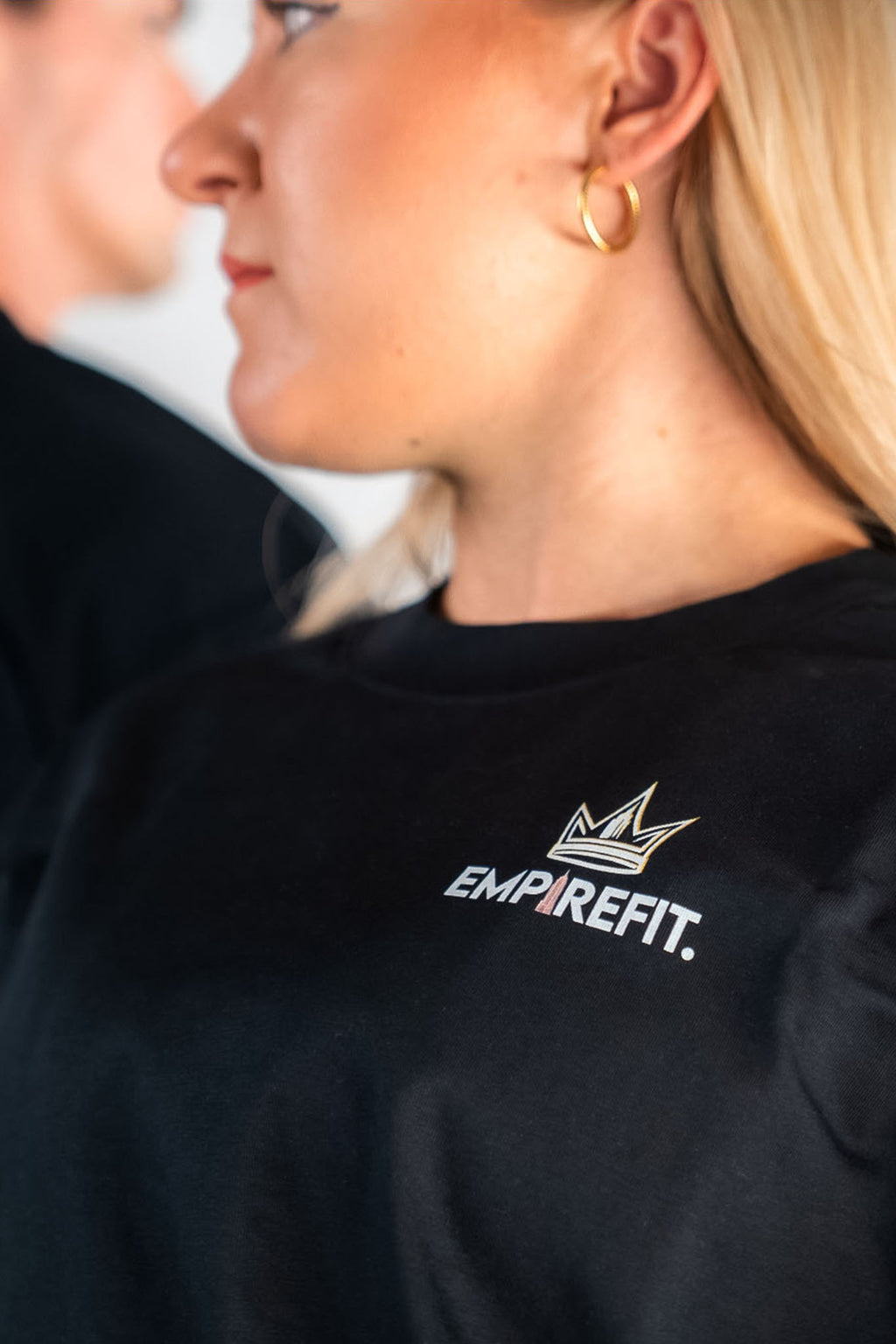 Close up of the Empire Fit crown logo black Essentials Crown Tee relaxed fit gym t-shirt by Empire Fit