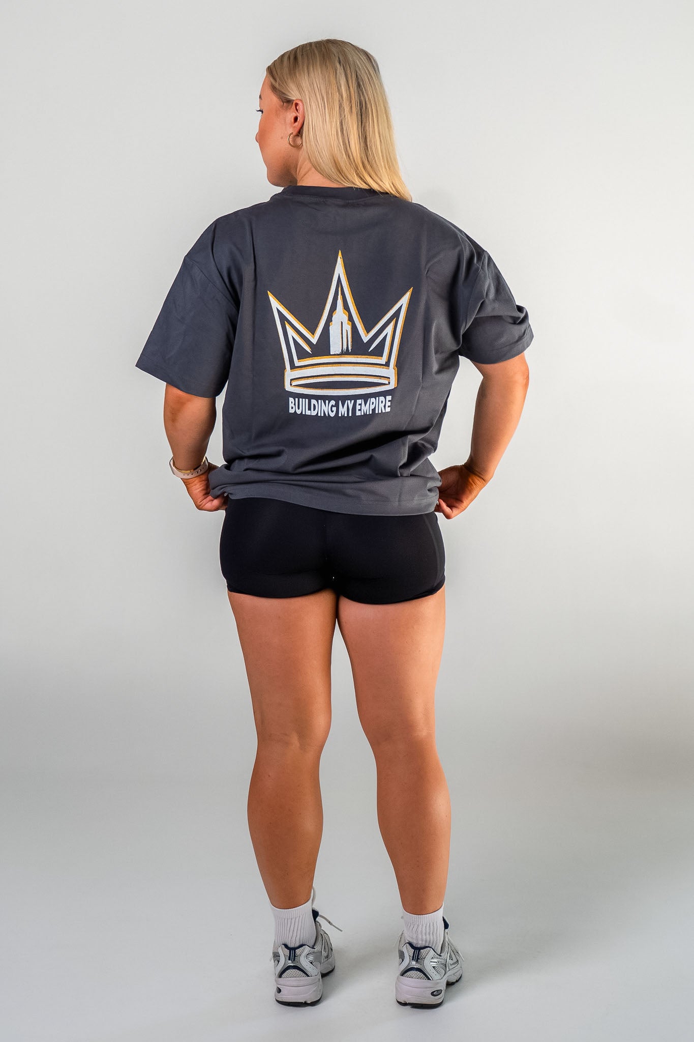 Female athlete wearing the charcoal Builders Tee relaxed fit gym t-shirt by Empire Fit back view