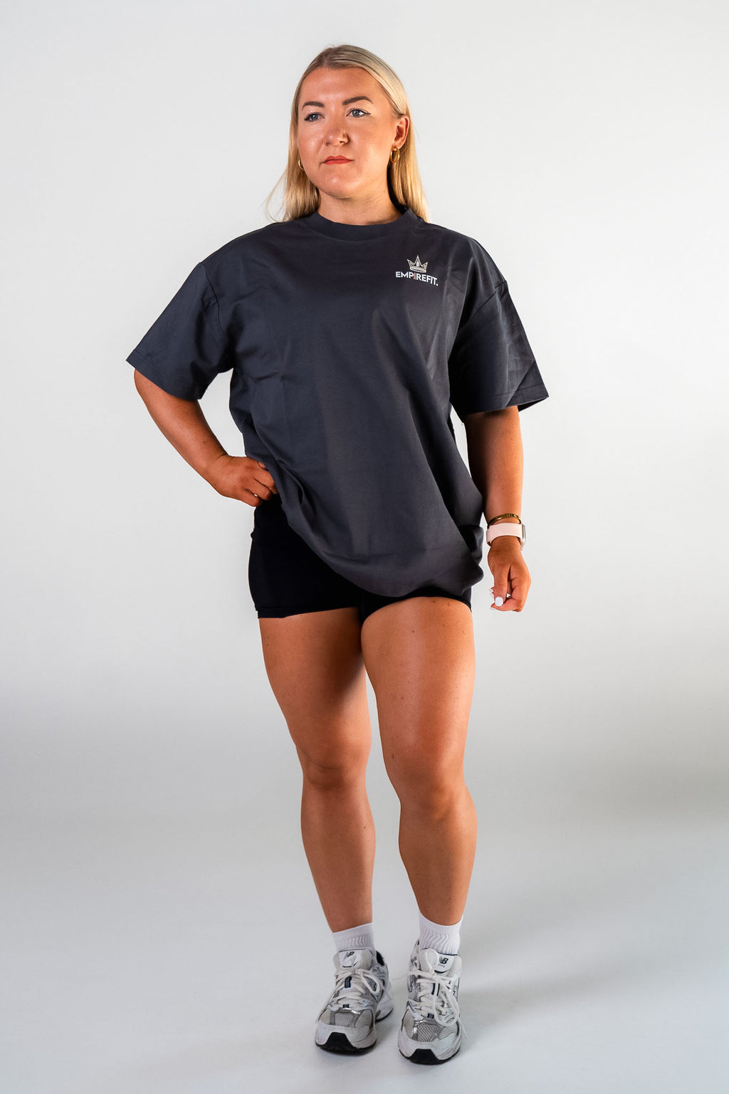 Female athlete wearing the charcoal Builders Tee relaxed fit gym t-shirt by Empire Fit front view