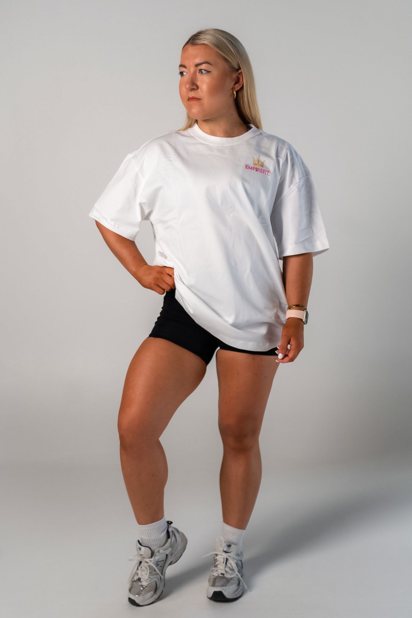 Female athlete wearing the pink Claim Your Crown Tee relaxed fit gym t-shirt by Empire Fit front view