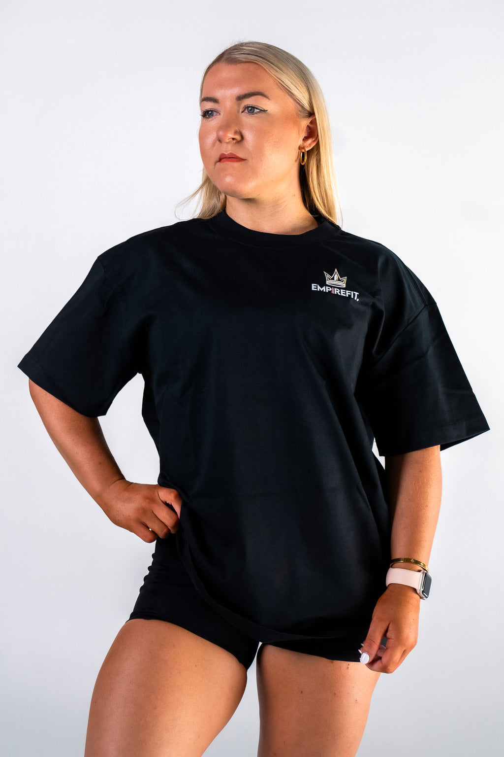 Front view of female athlete wearing the black Builders Tee relaxed fit gym t-shirt Building My Empire graphic by Empire Fit