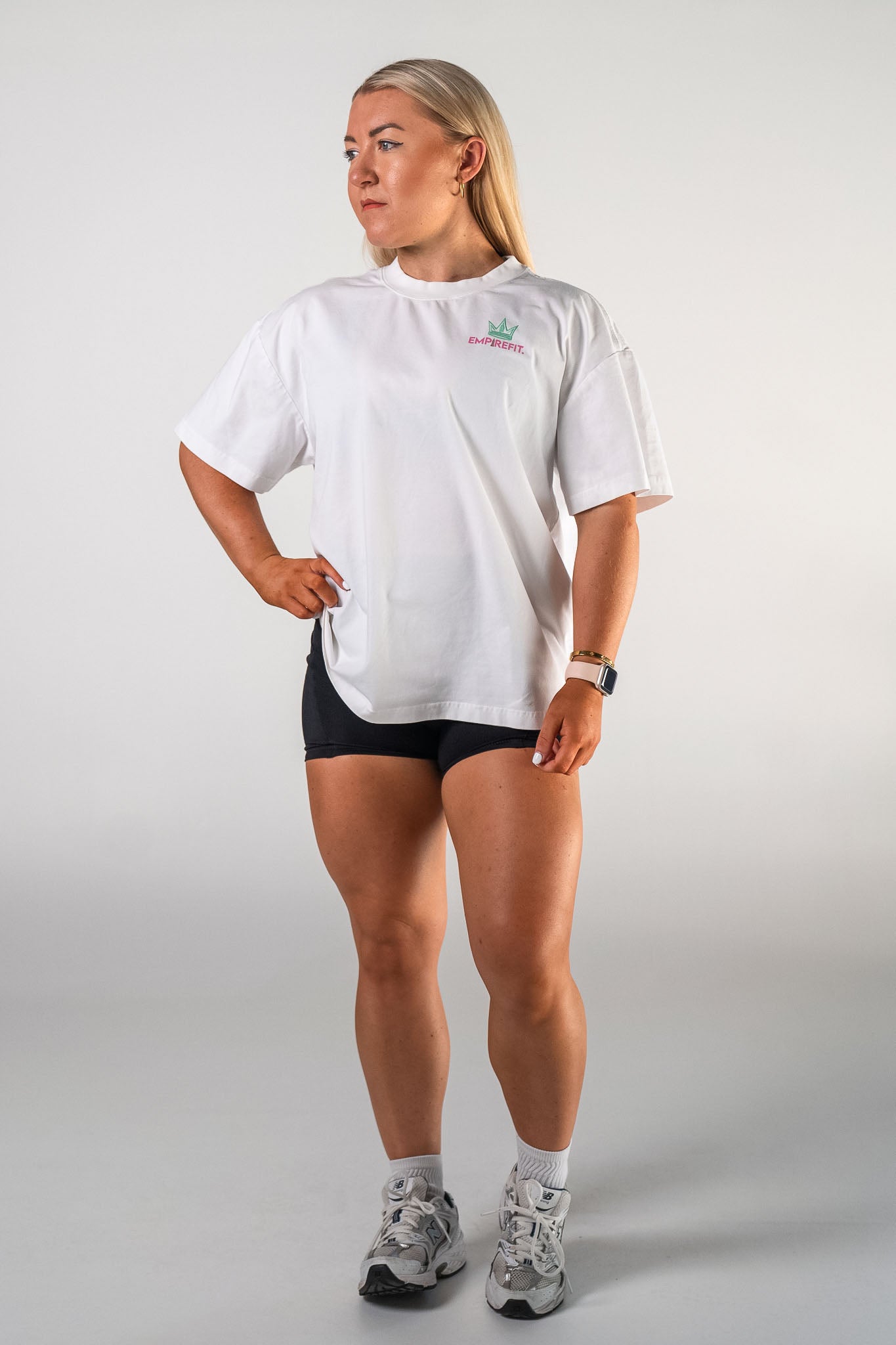 Front view of female athlete wearing the white Busy Building tee graphic gym t-shirt motivational fitness apparel by Empire Fit