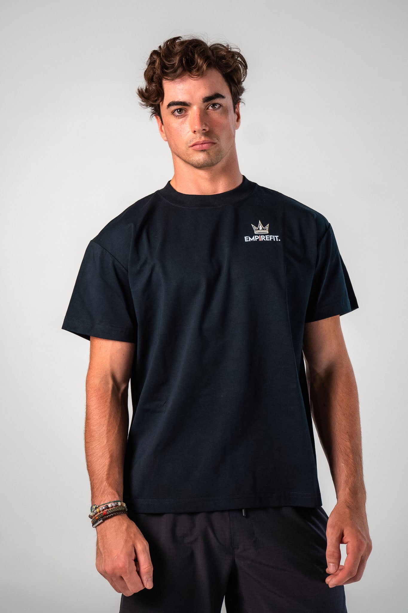 Front view of male athlete wearing the black Builders Tee relaxed fit gym t-shirt Building My Empire graphic by Empire Fit