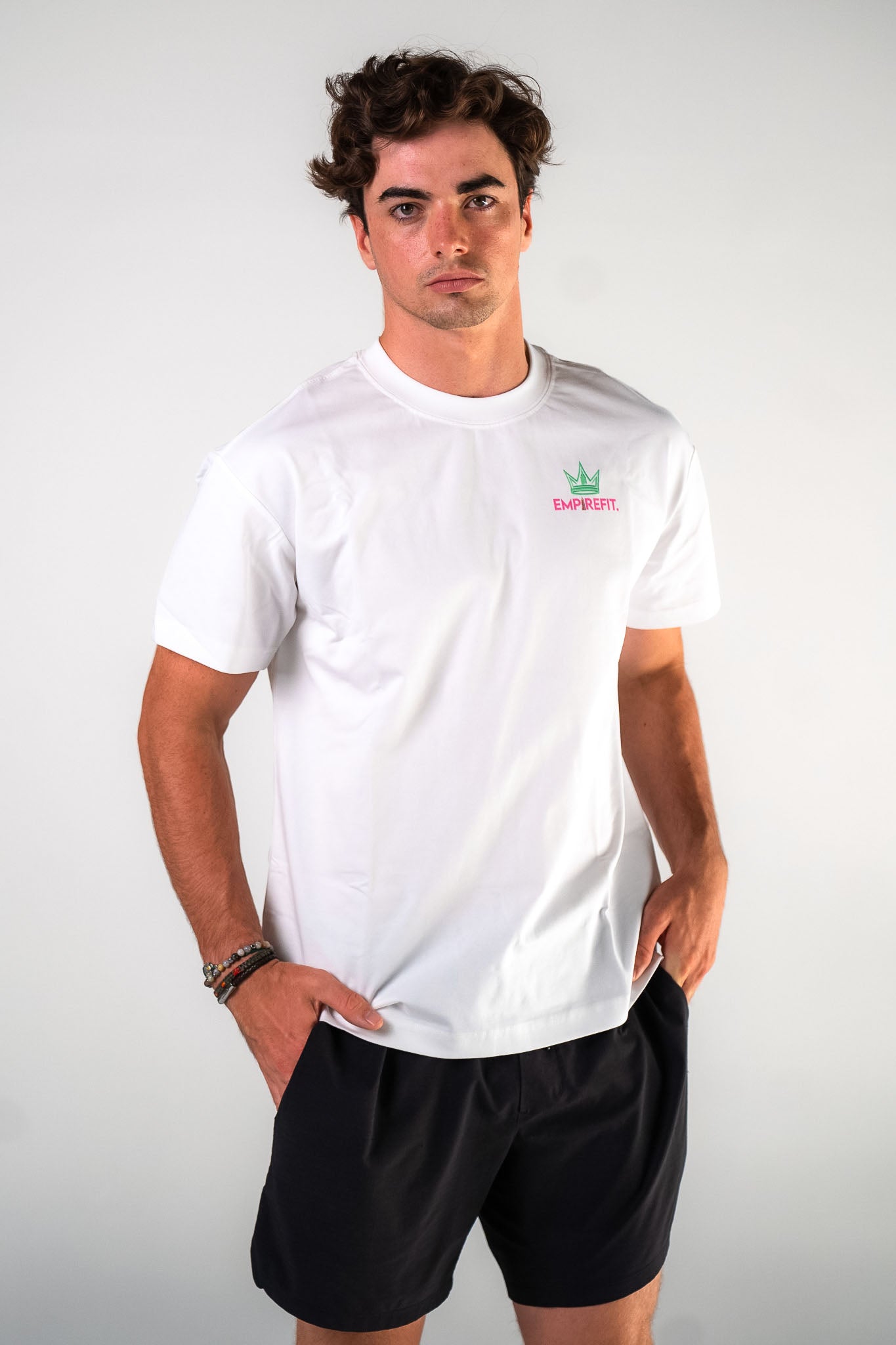 Front view of male athlete wearing the white Busy Building My Empire tee graphic gym t-shirt motivational fitness apparel by Empire Fit