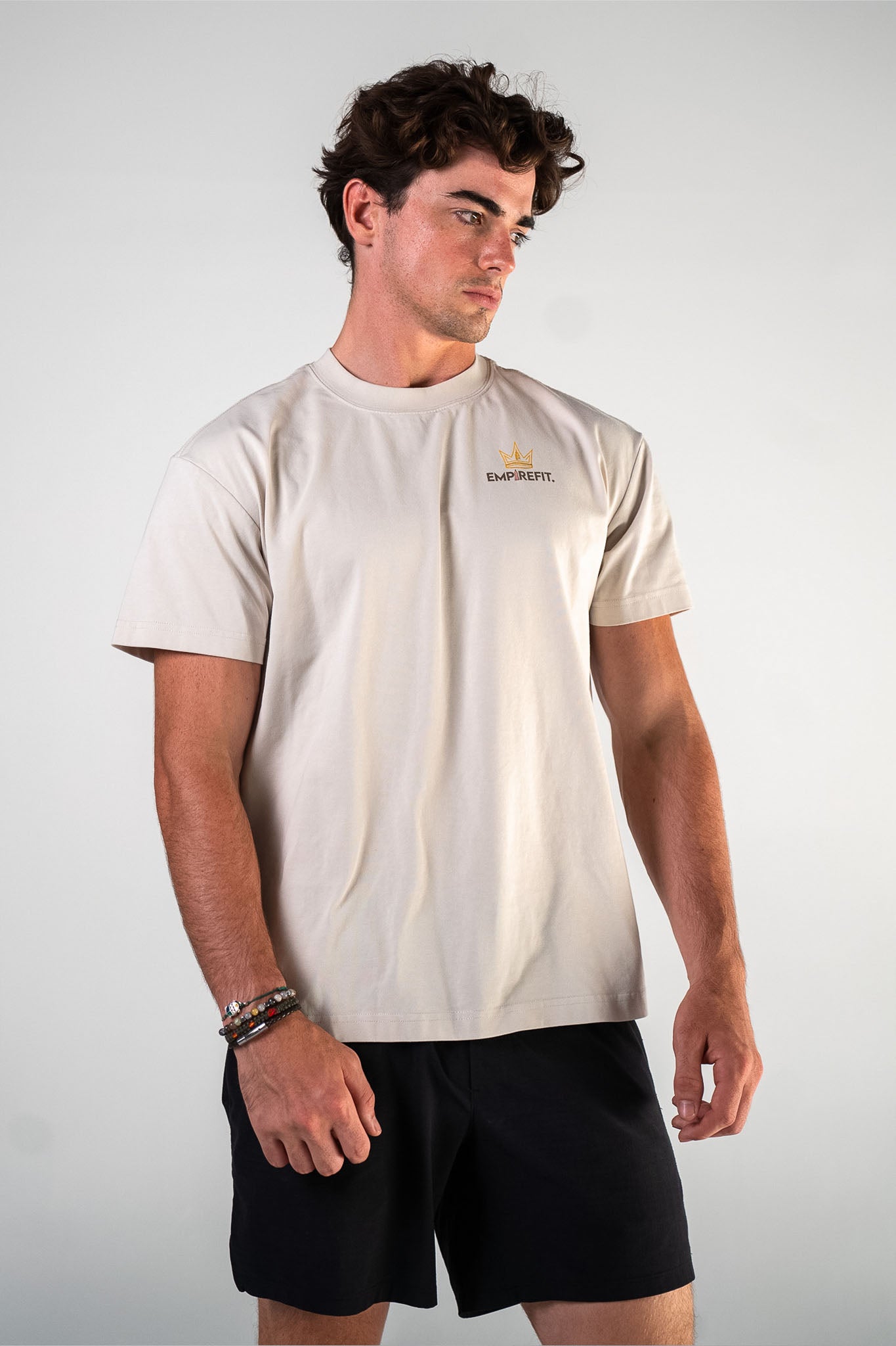 Front view of the beige Essentials Crown Tee relaxed fit gym t-shirt by Empire Fit