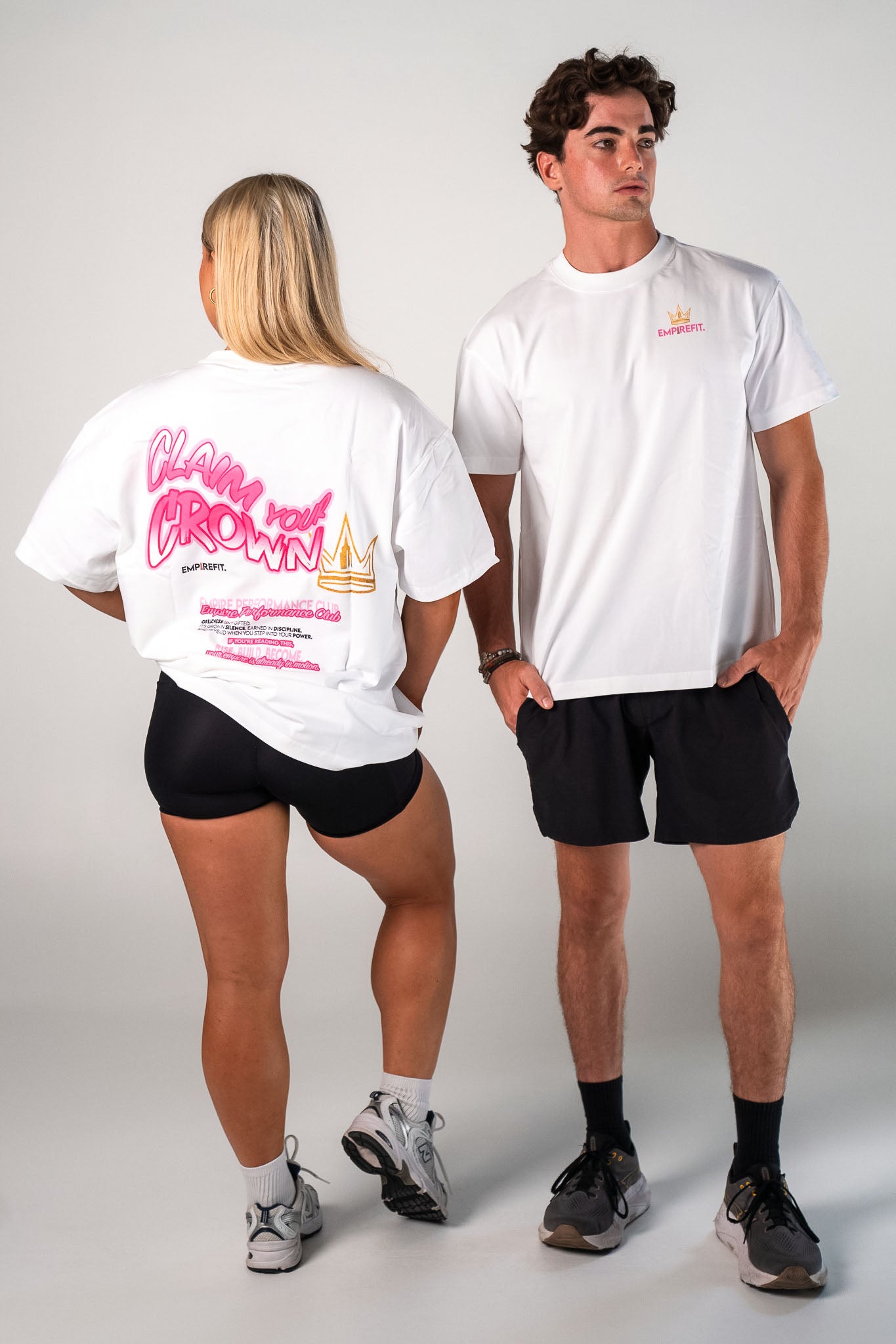 Male and female athletes wearing the pink Claim Your Crown Tee gym t-shirt by Empire Fit
