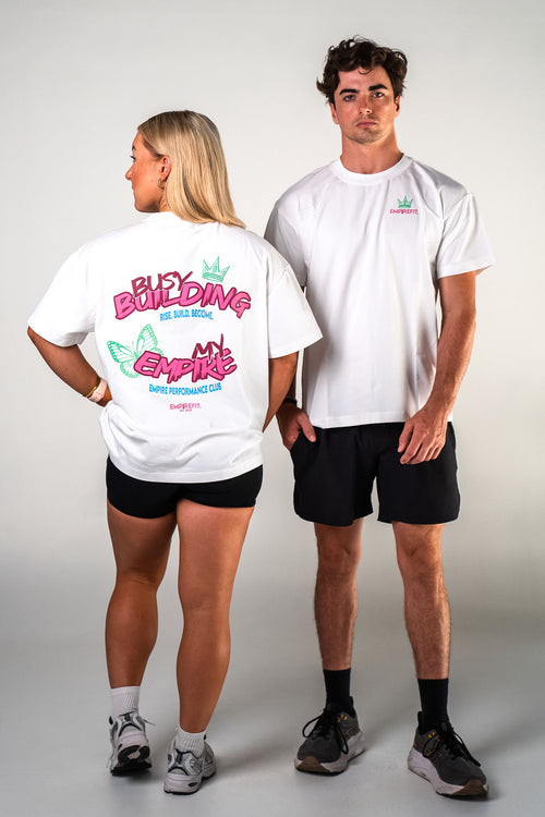 Male and female athletes wearing the white Busy Building My Empire graphic gym t-shirt by Empire Fit