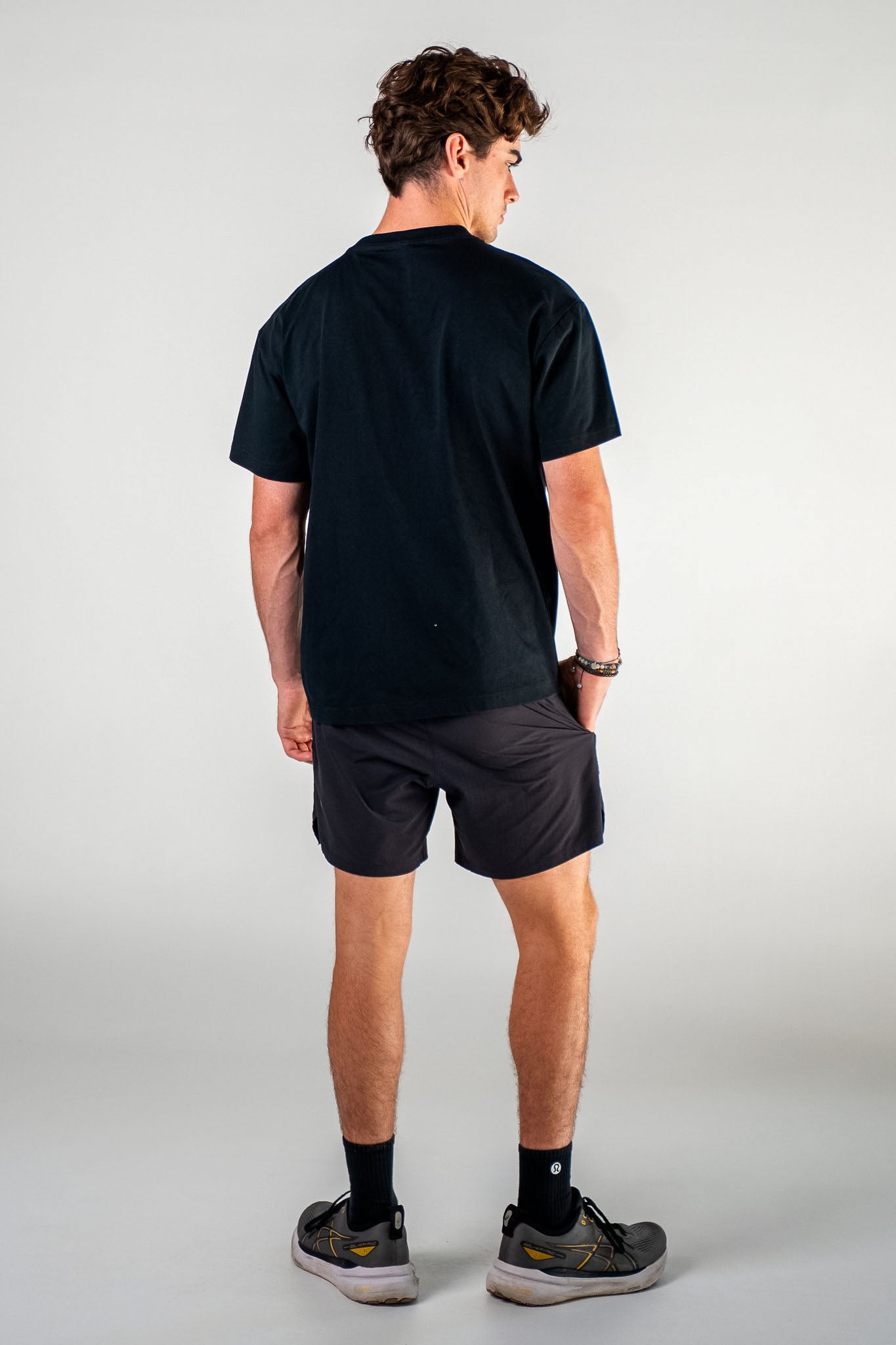 Male athlete wearing the black Essentials Crown Tee relaxed fit gym t-shirt by Empire Fit