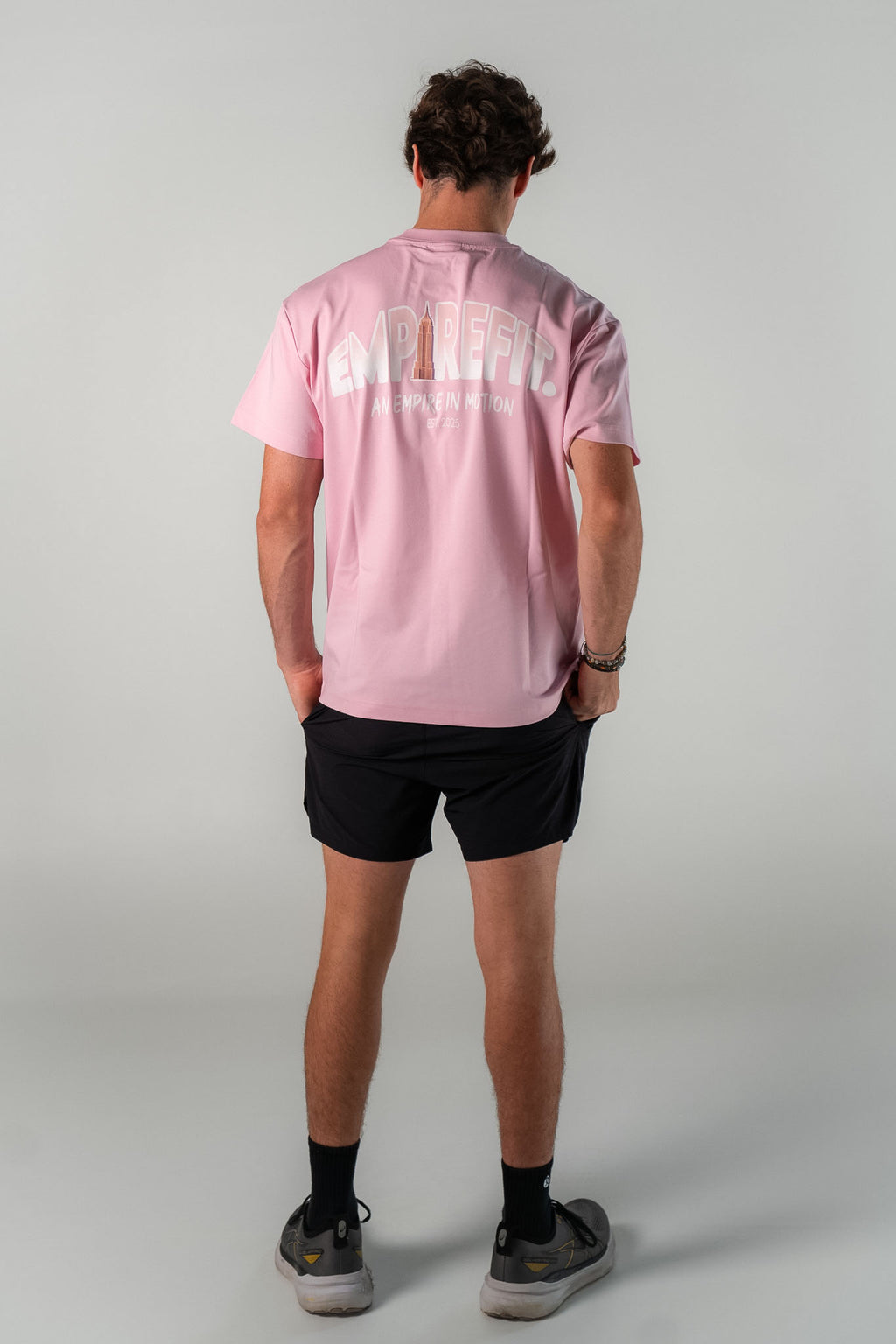 Male athlete wearing the blush Empire in Motion Tee by Empire Fit back graphic