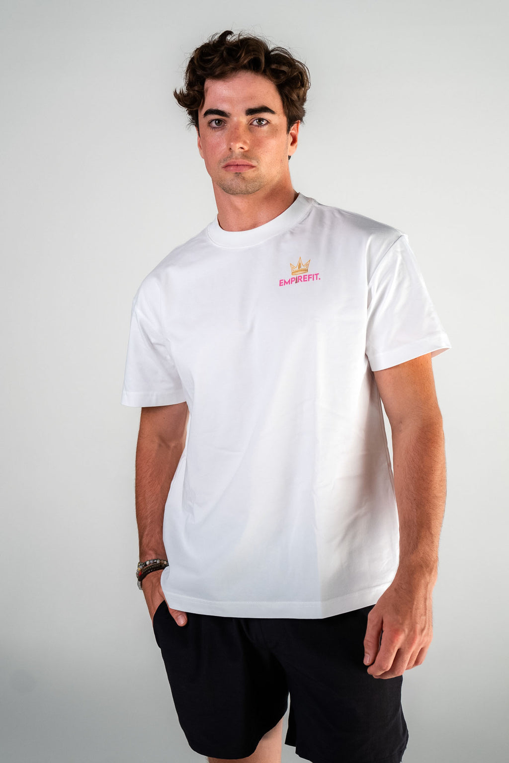 Male athlete wearing the pink Claim Your Crown Tee relaxed fit gym t-shirt by Empire Fit front view